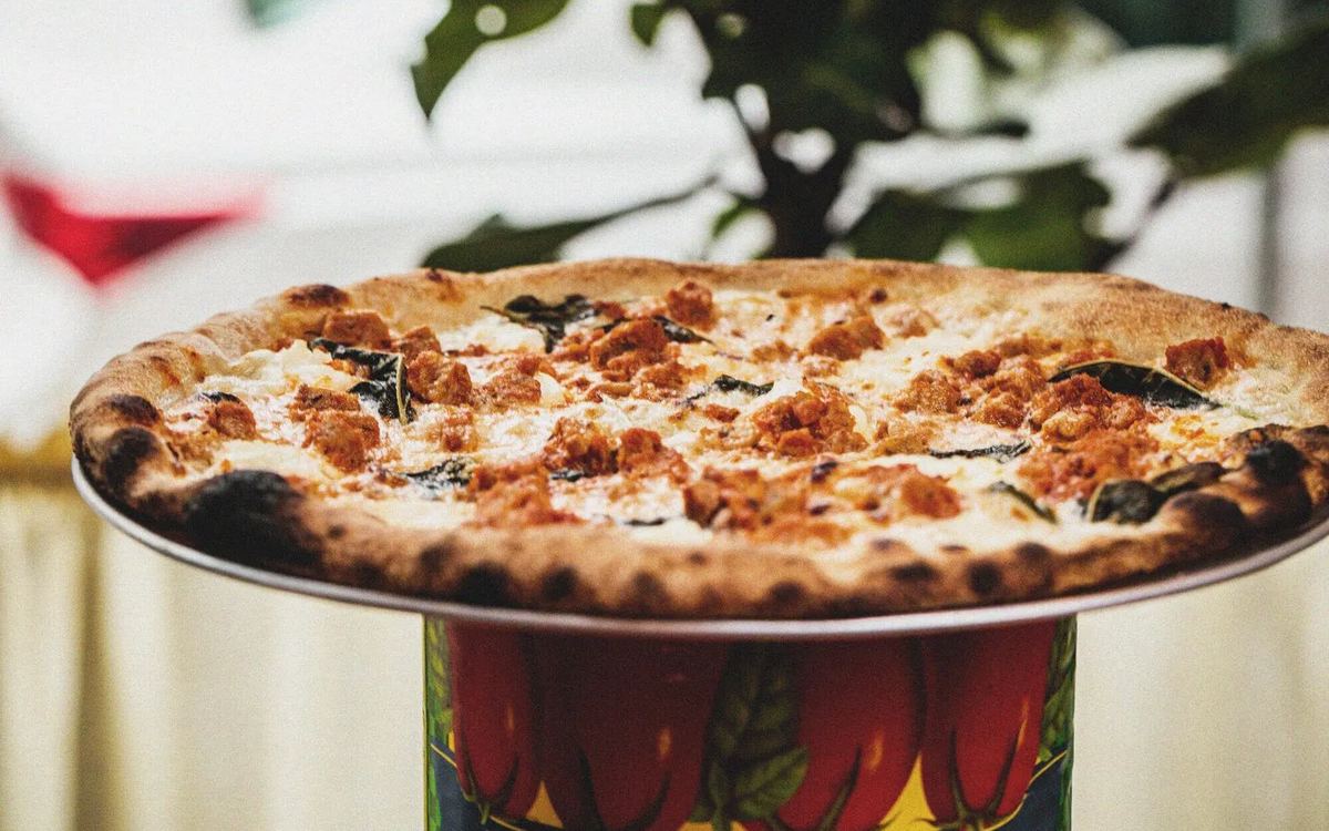 A pizza on a stand at Bar Rosina's