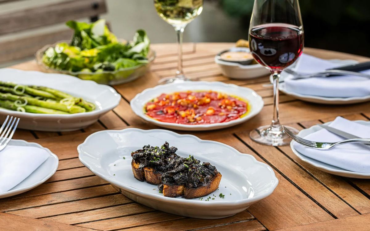 Shared plates and wine on a table at Bedford Post