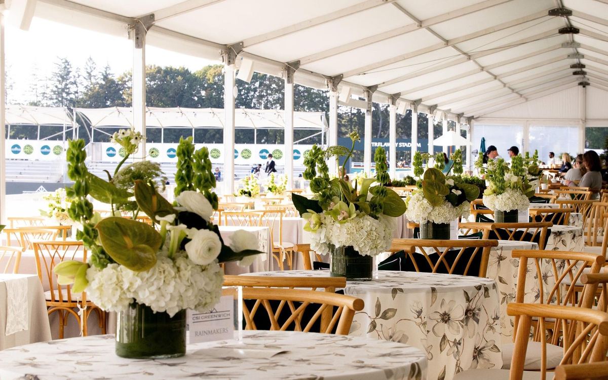Tables set under the hospitality tent at CSI Greenwich