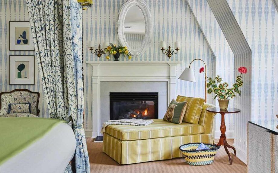 A guest room with a fireplace at the Mayflower Inn