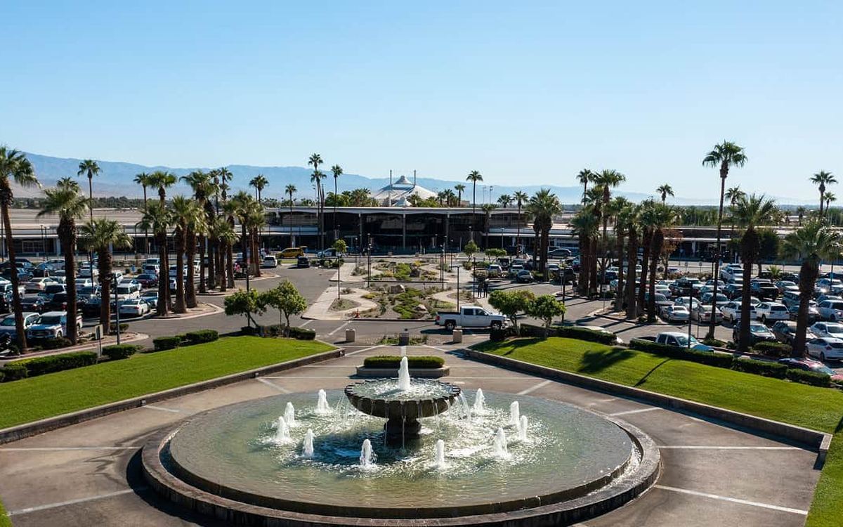 Palm Springs International Airport entrance with fountain and palm trees
