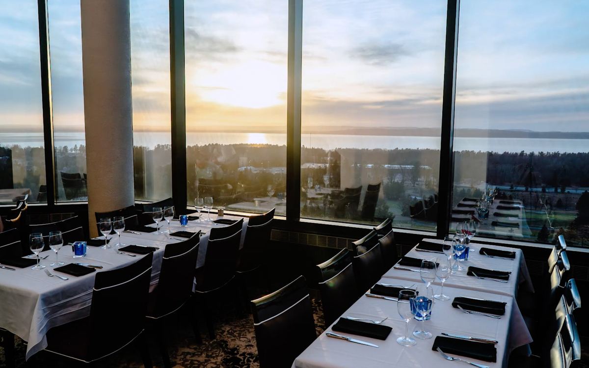Window tables at sunset over Grand Traverse Bay in Aerie Restaurant