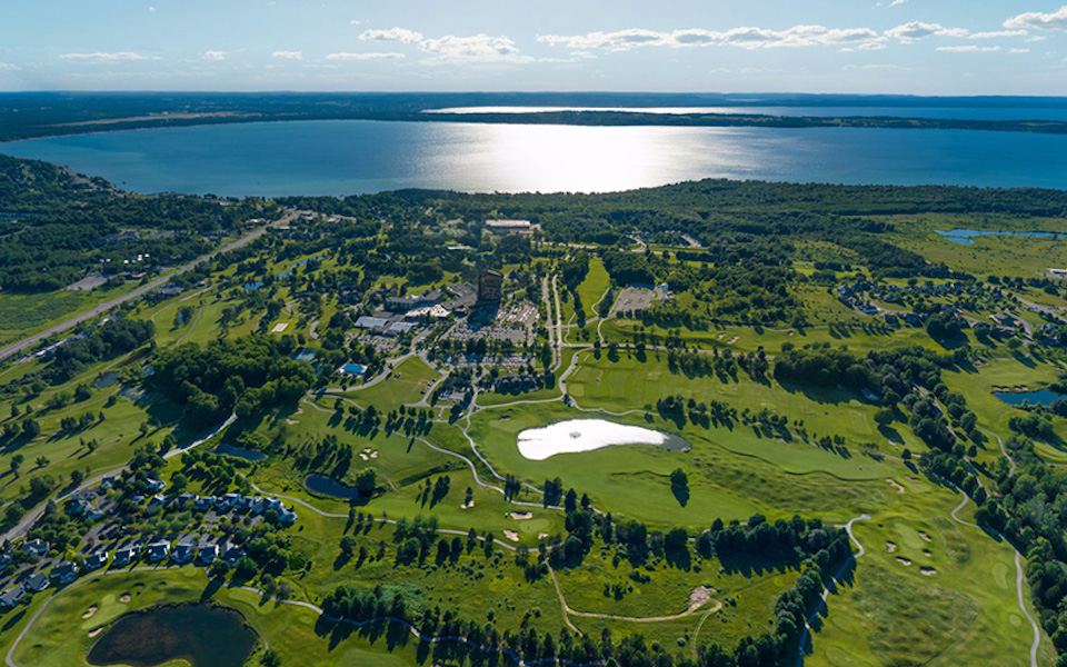 Aerial view of Grand Traverse Resort and Spa and its golf courses beside Grand Traverse Bay