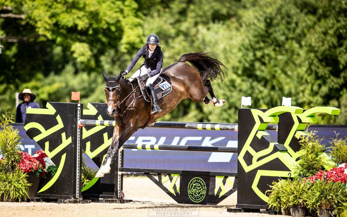 A horse and rider clear a fence at the Great Lakes Equestrian Festival