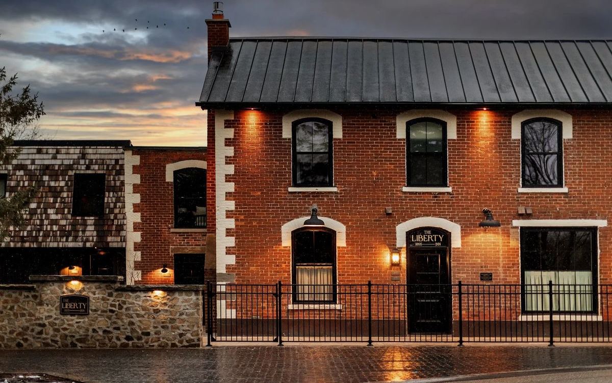 The Liberty Inn, a brick building in Alton, at dusk