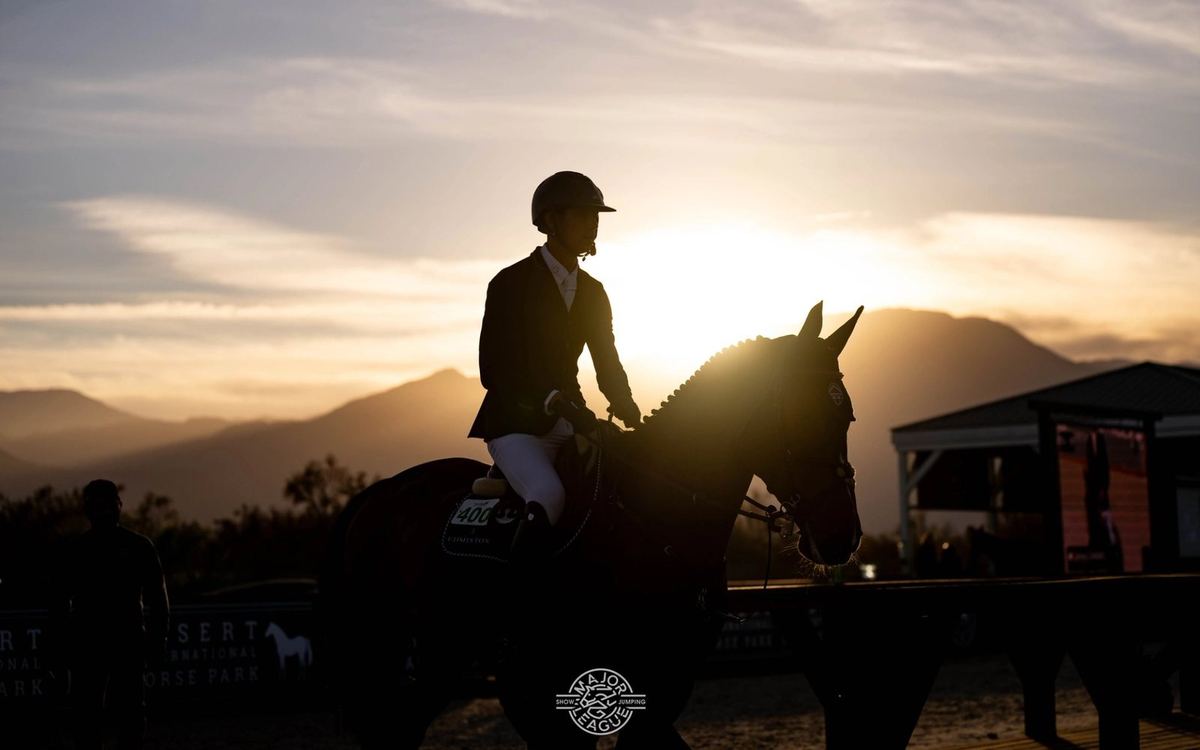 A rider and horse silhouetted at sunset in the Coachella Valley